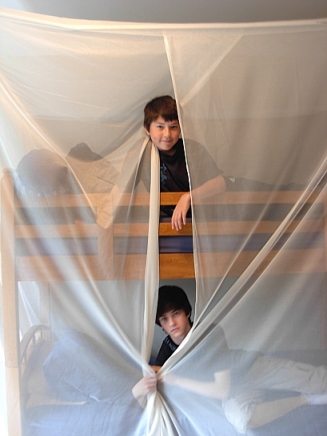 Jaden & Evan Jeske sleep under a shielding canopy to block external microwave radio frequencies from the four cell towers nearby. (Photo © Kim Goldberg, 2013)
